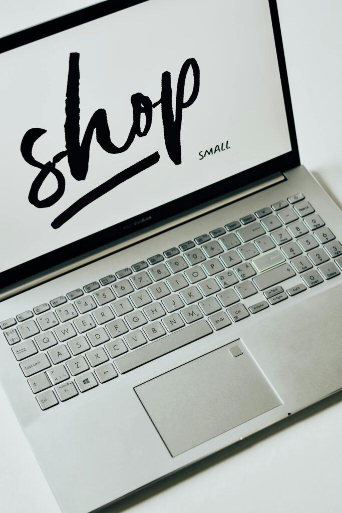 A focused image of a laptop displaying 'shop small' on the screen, promoting small businesses.